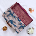 Semi Chanderi saree with cow motif print beige and teal body with maroon zari border folded top view