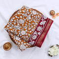 Semi Chanderi saree with white floral print yellow body and maroon border folded top view