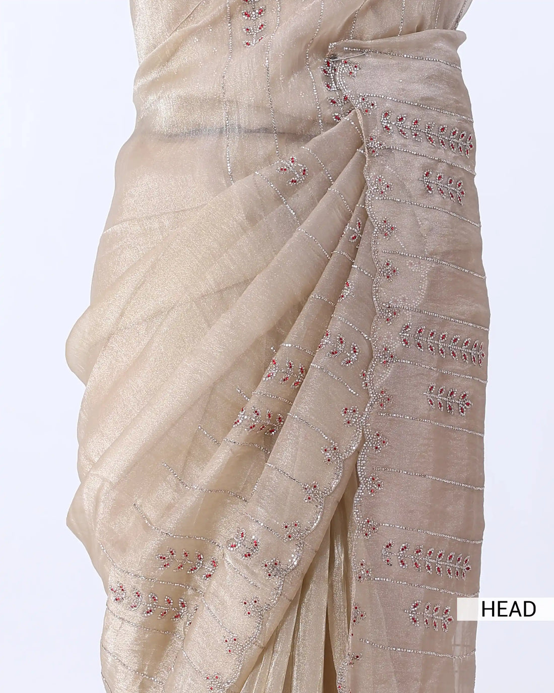 A light beige saree with a subtle printed pattern