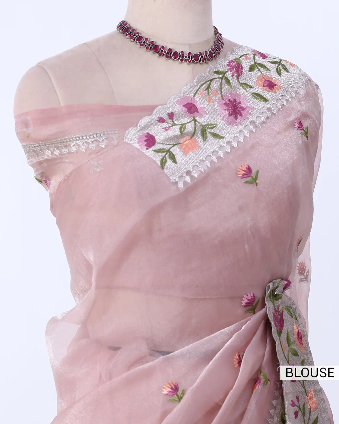 A folded dusty pink embroidered dupatta with floral patterns and a gray border