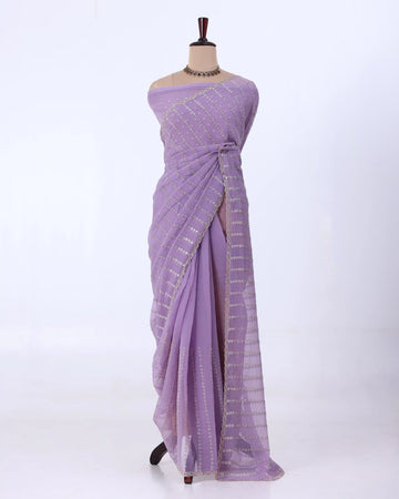 A lavender purple saree with gold zari vertical stripes