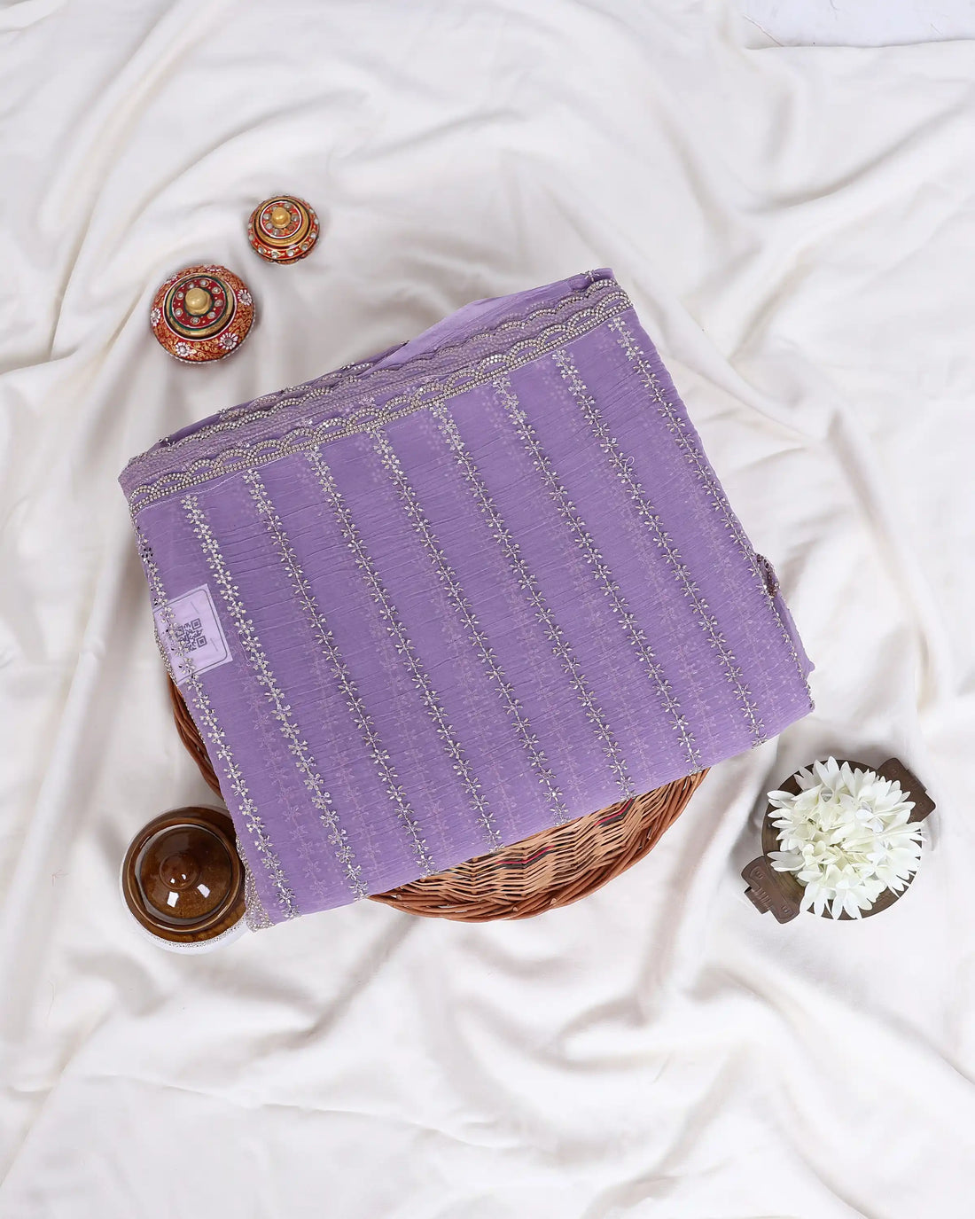 A lavender purple saree with gold zari vertical stripes