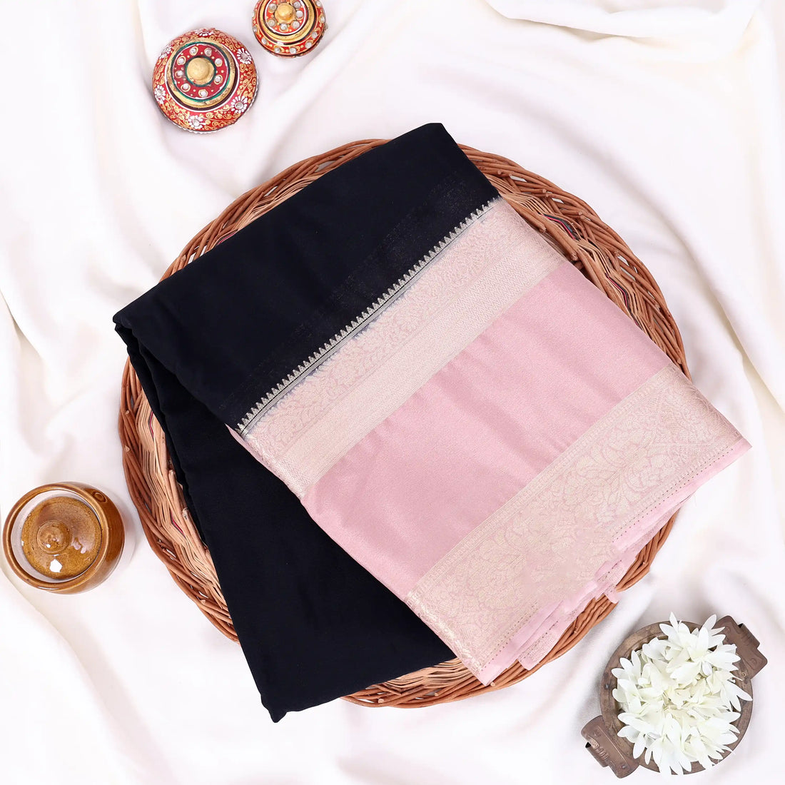 Mysore Silk saree with plain black body and silver with pink zari woven border, front drape view