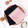 A folded black mysore silk saree features a wide border with a pink and silver zari detailing.