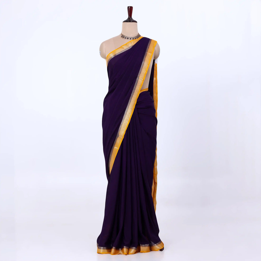 Mysore Silk saree with plain black body and gold with yellow zari woven border, front drape view