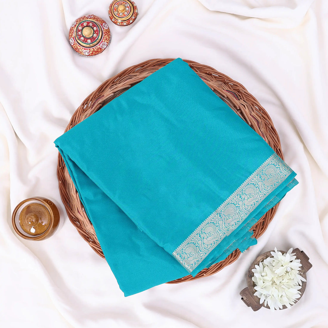 Mysore Silk saree with plain turquoise blue body and silver zari woven border, front drape view