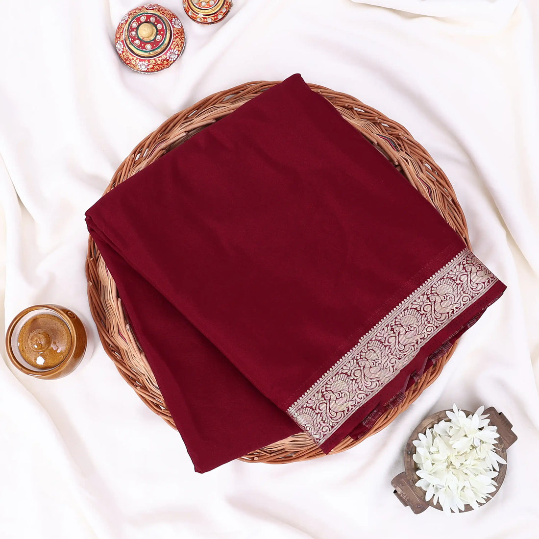 Mysore Silk saree with plain deep maroon body and silver zari woven border, front drape view