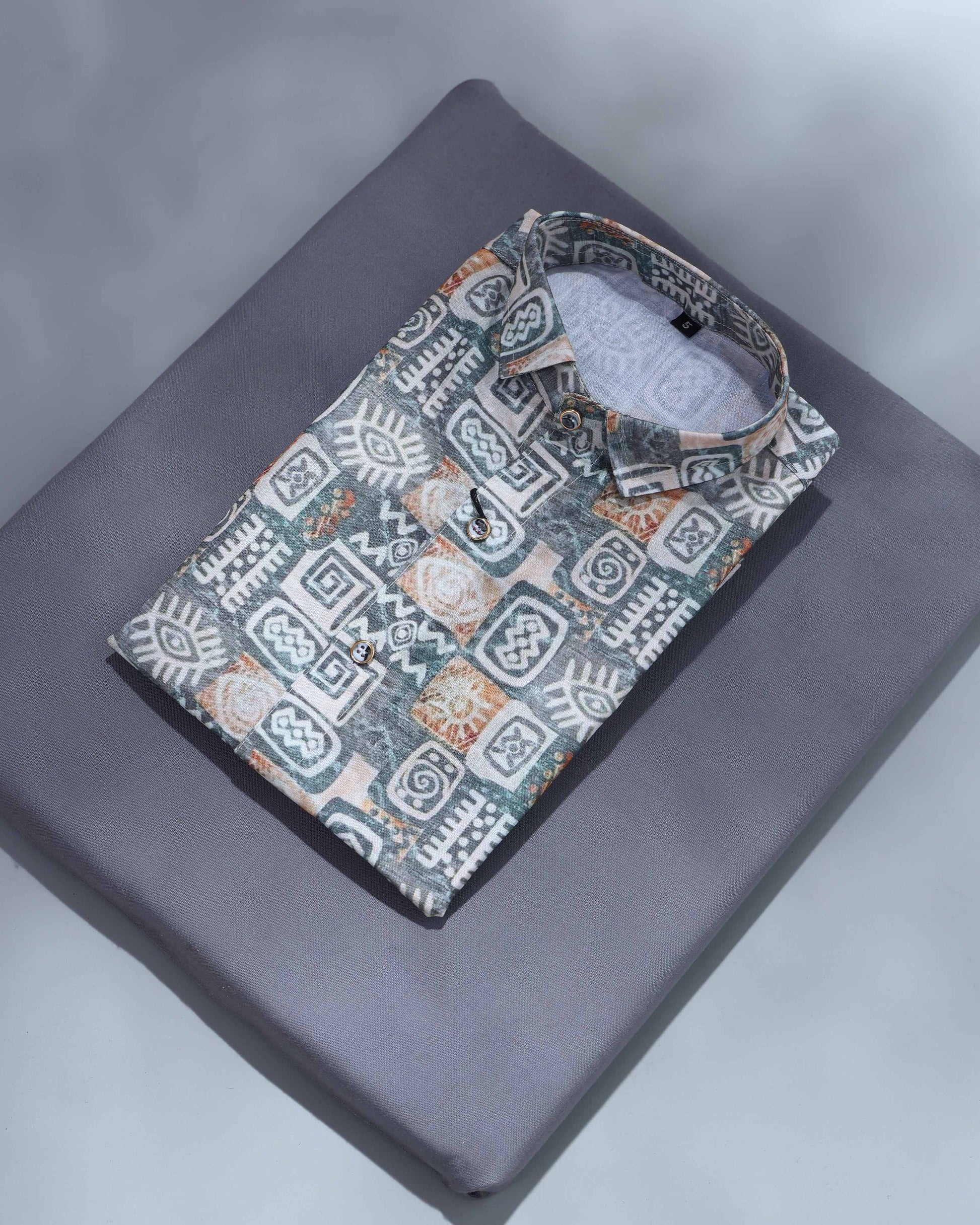 Patterned shirt on a gray surface