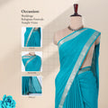 A turquoise blue saree with a silver patterned border with details of head, blouse, and pallu